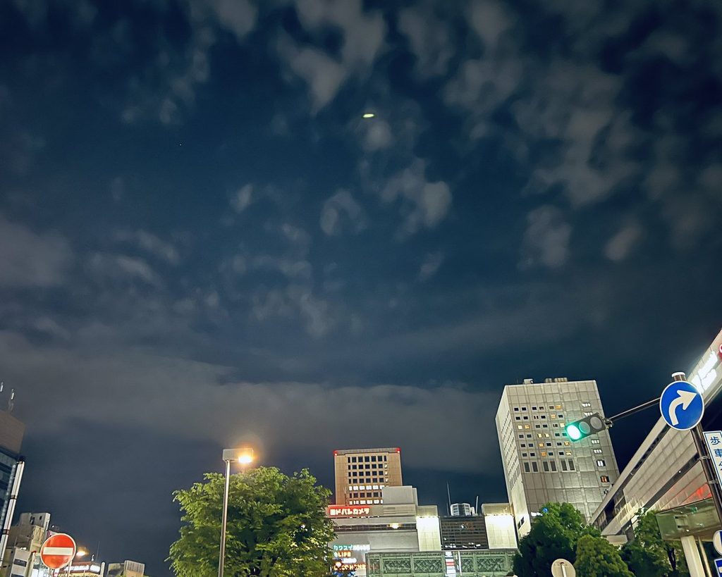 夕暮れの空と駅前のビル